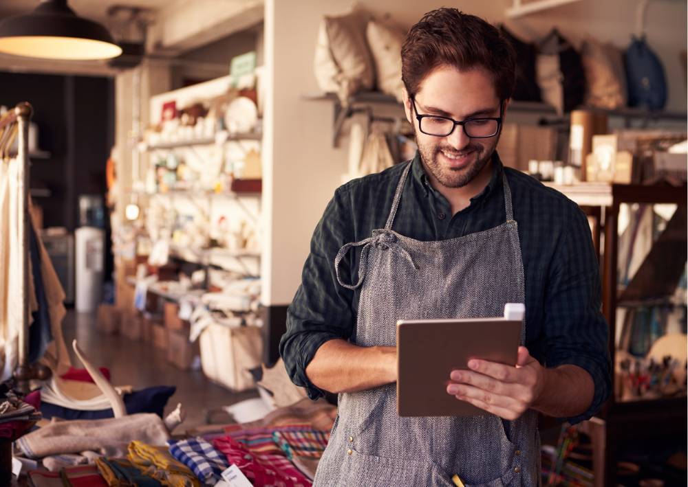Shop owner entering inventory on a tablet